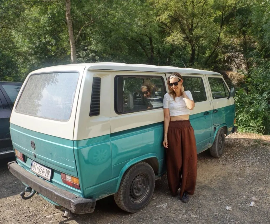 a woman next to a volkswagen van