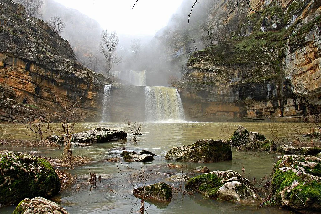 A waterfall in the rocks, falling into a pool