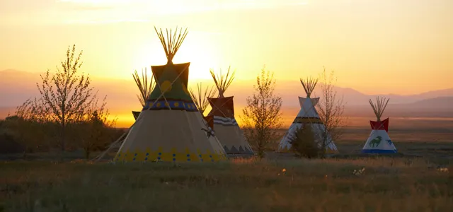 tipi glamping tents at sunset