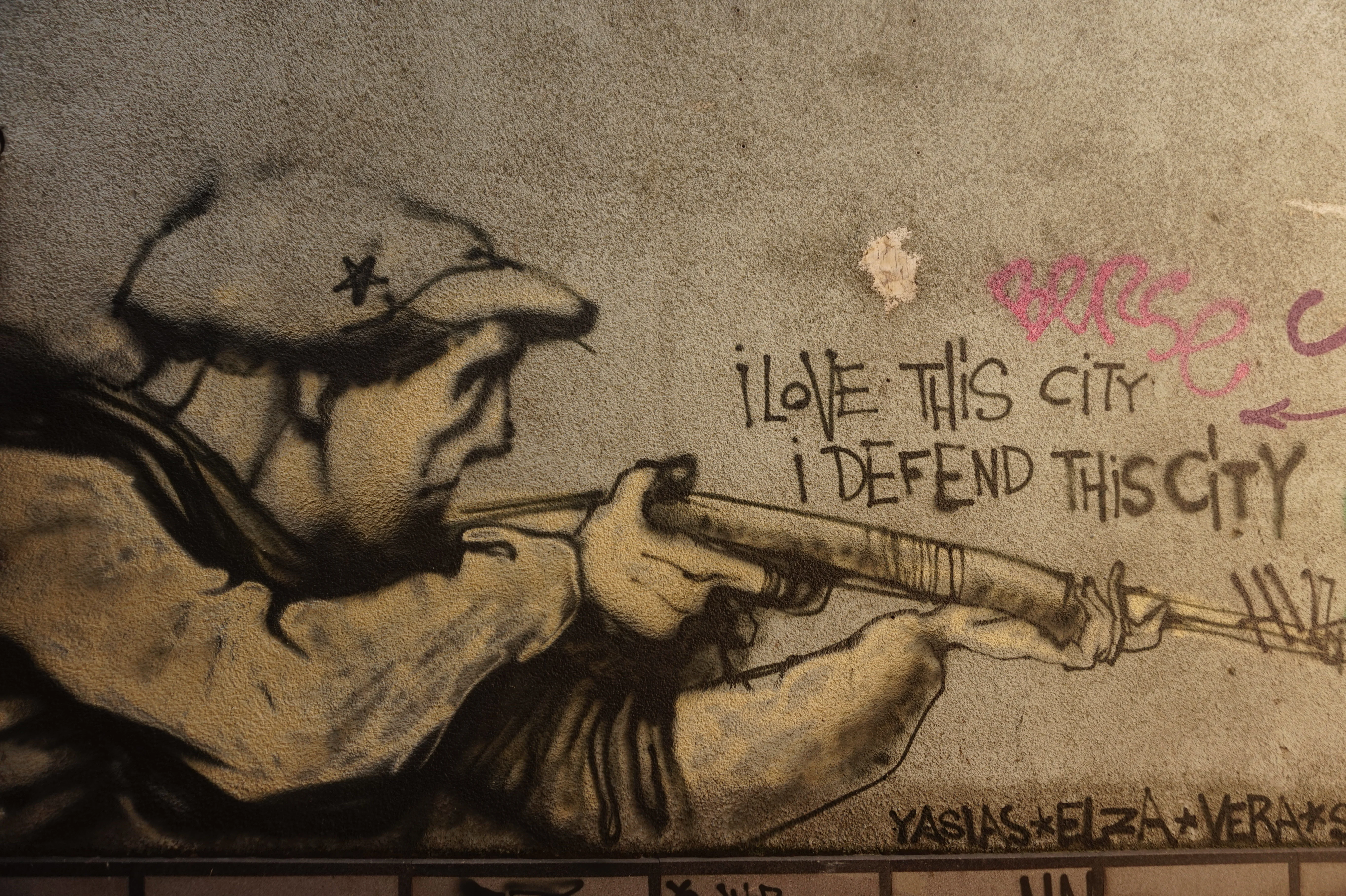 Memories of the war are still very alive in Sarajevo, with a  mural that shows a man with a gun, and the text ''i love this city, i defend this city''