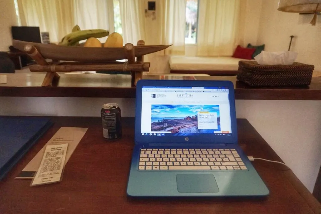 A laptop set in a wooden table