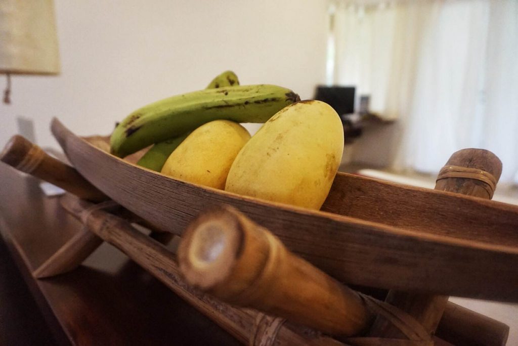 close up image of a bowl with bananas and mangos