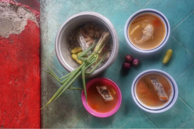 Overview image of four bowls with soup and bits of meat