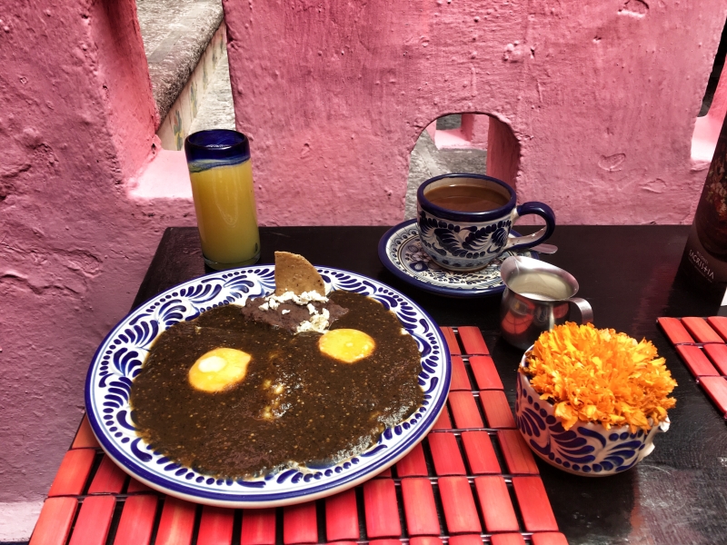 Mexican Breakfast and a cup of coffee in a small table 