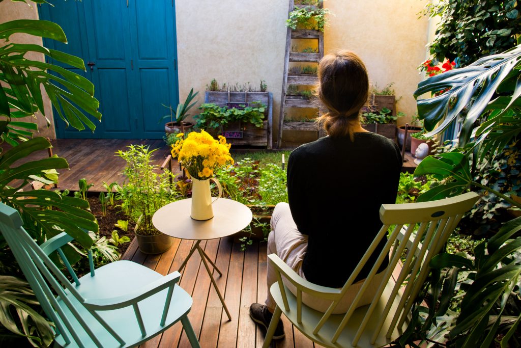 A woman sitting in a patio at Casa Lum, a hotel in San Cristobal de las Casas