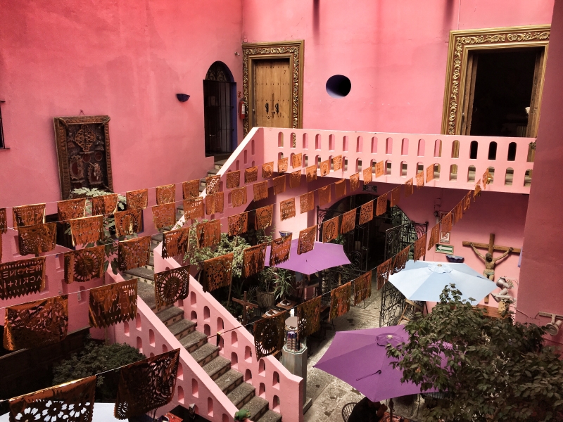 the pink courtyard of a Mexican hotel