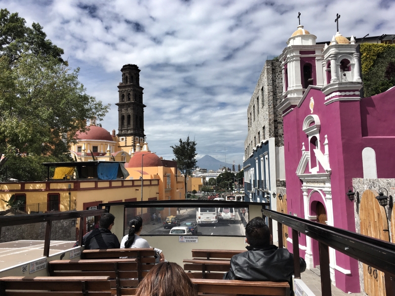 Photo of a street in Puebla, taken from the top of a tourist bus