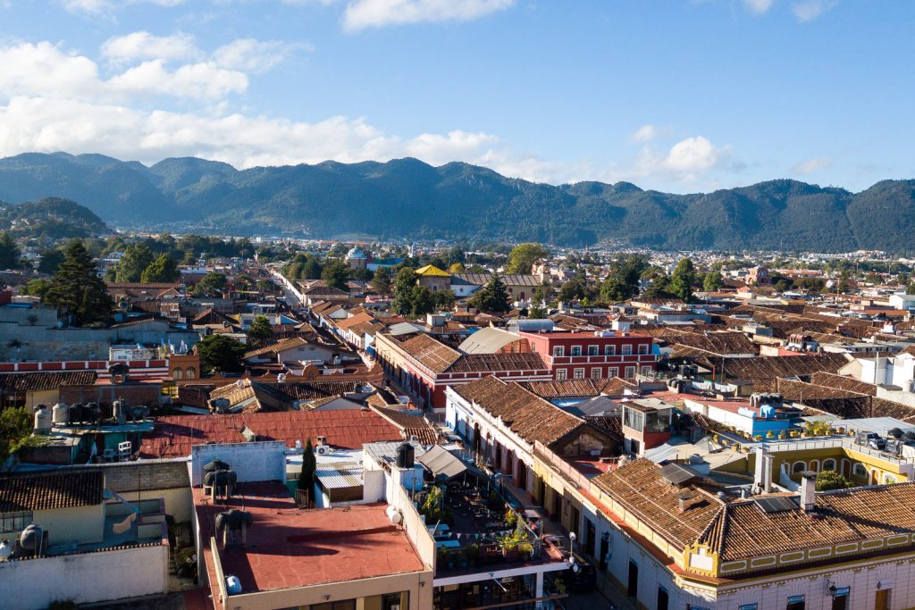 A lanscape of house roofs and mountains in the background, inserted in a post about Casa Lum Review