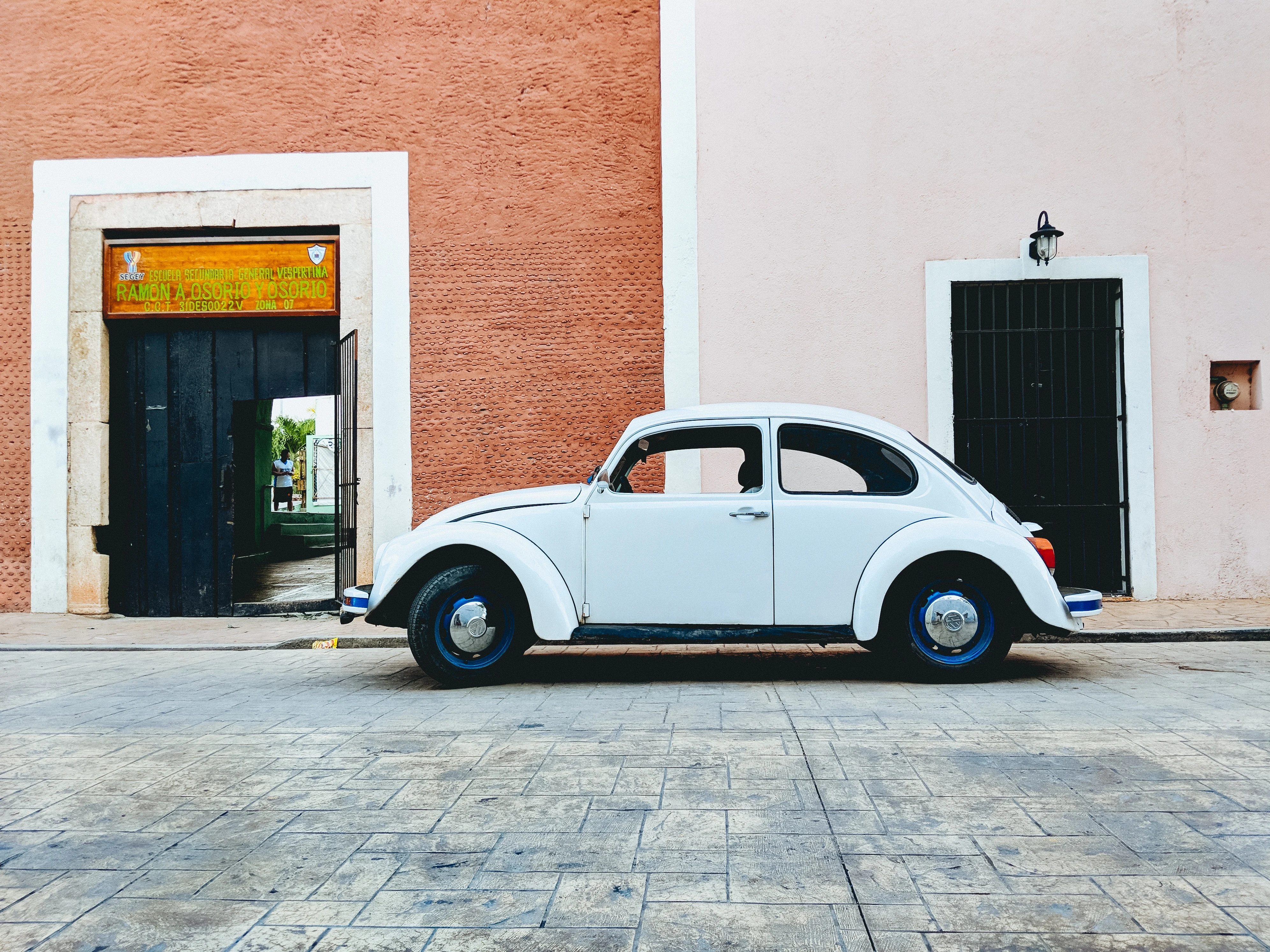 A baby blue beetle car parked on the streets of Valladolid 