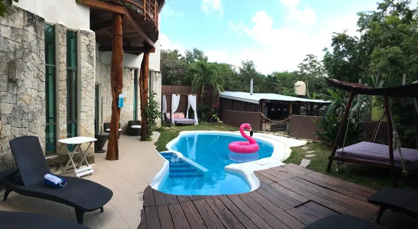 A swimming pool with a pink flamingo floatie 