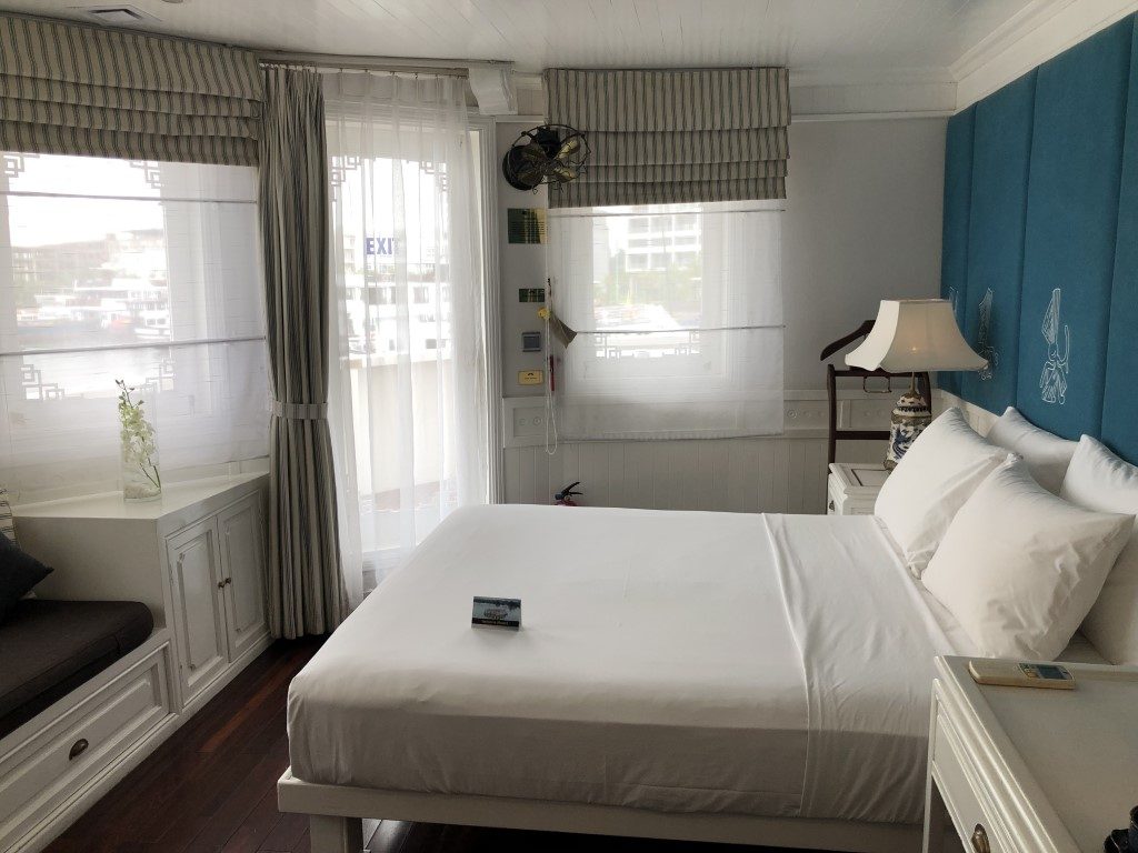 A cabin room with a double bed in a cruise boat