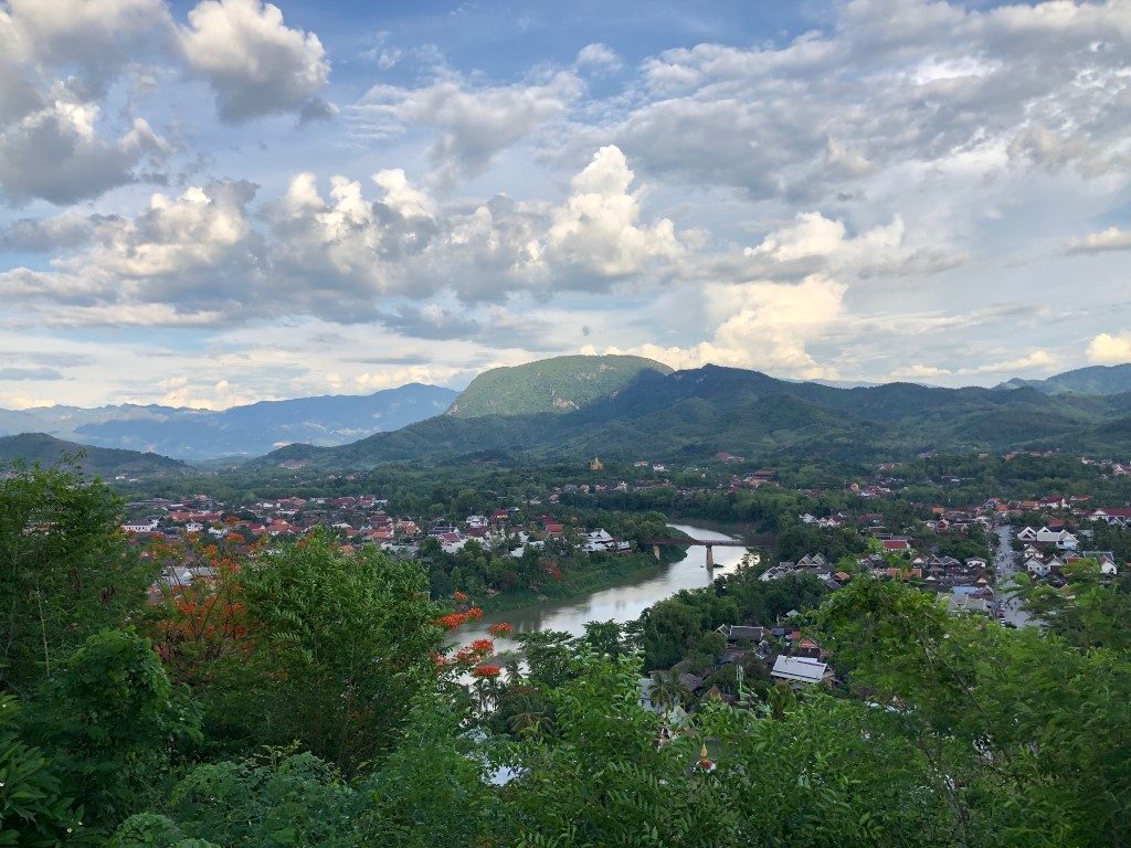 A viewpoint panorama of Luang Prabang, with the river flowing between lush vegetation