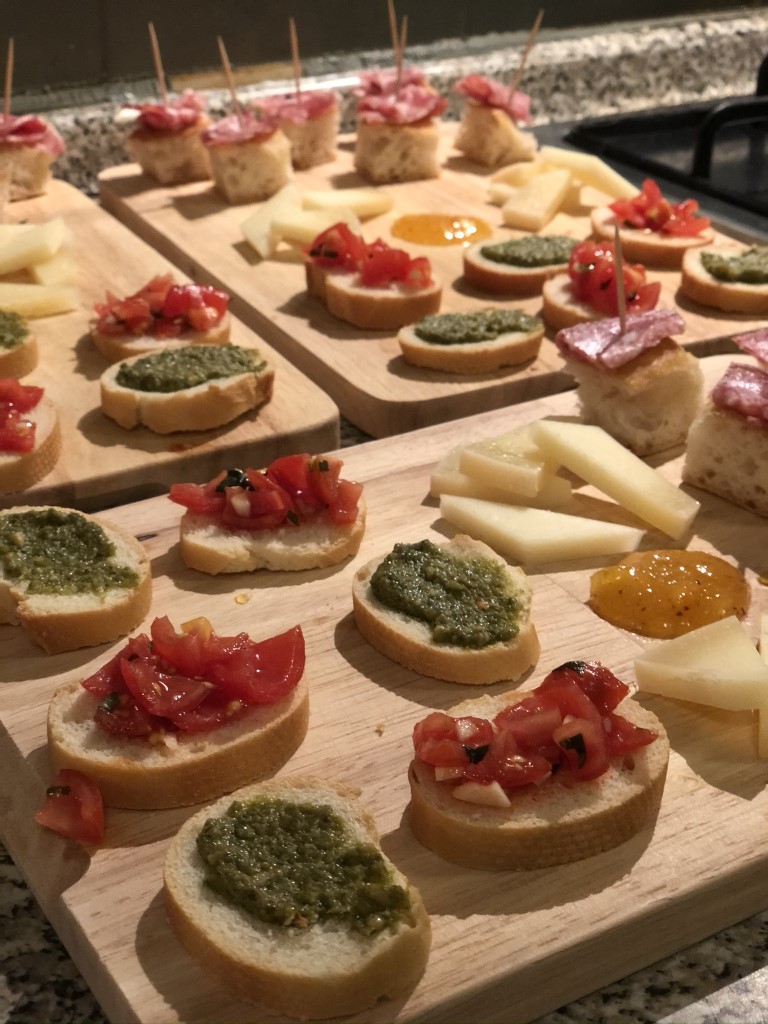 Italian Bruschetta, cheese, and jam placed on three wooden boards during a cooking class