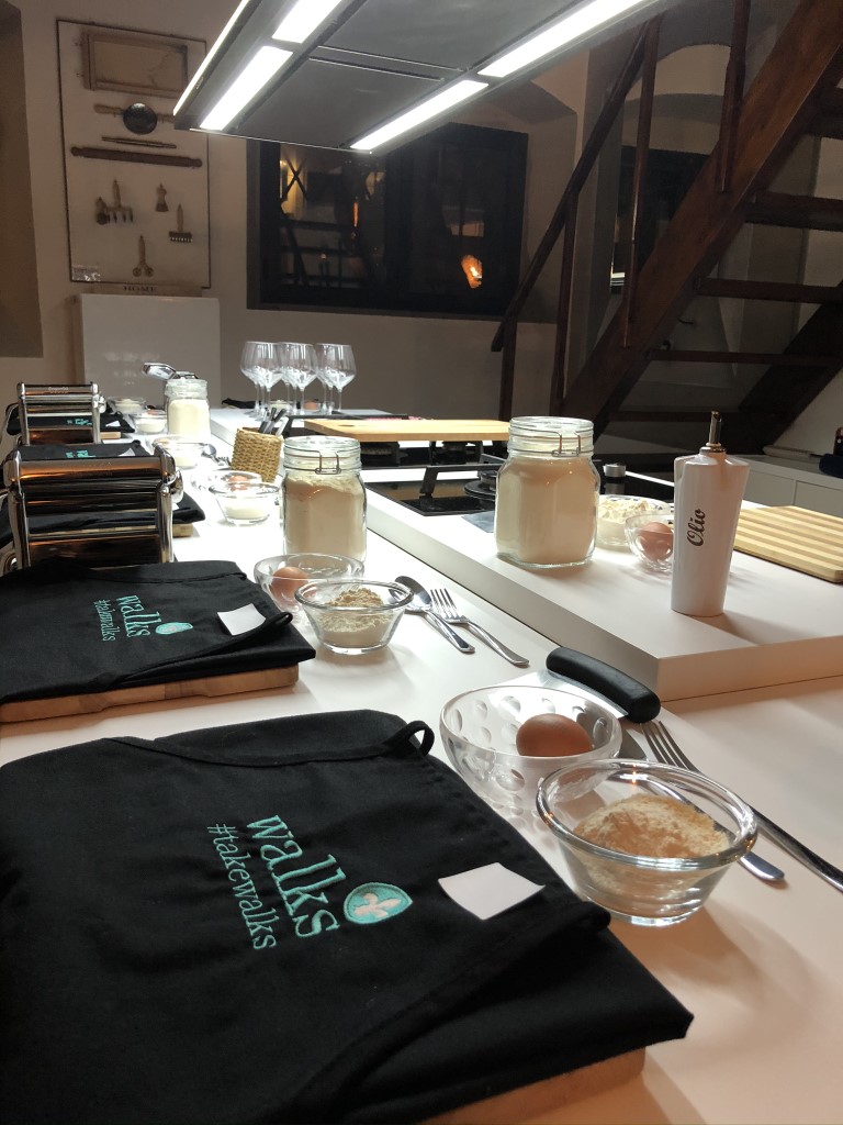 A cooking station with aprons and ingredients during a cooking class in Florence, Italy 