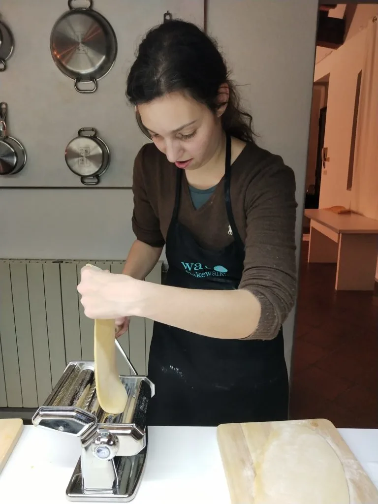 A woman making fresh pasta during a cooking class, inserted in a post about a 2 days in Florence itinerary