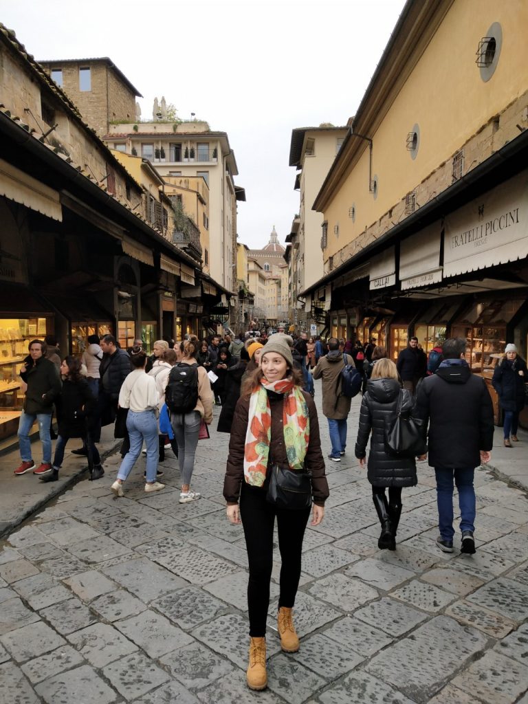 A woman crossing Ponte Vecchio in Florence 