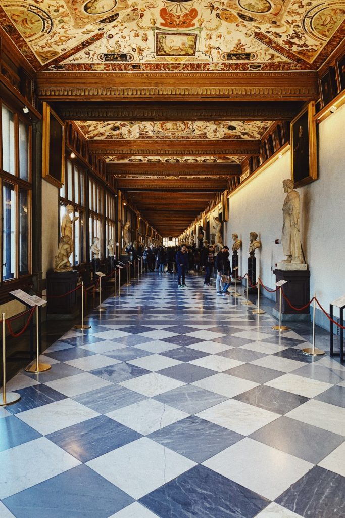 Image of the Uffizi Gallery, with sculptures located on both sides of a corridor