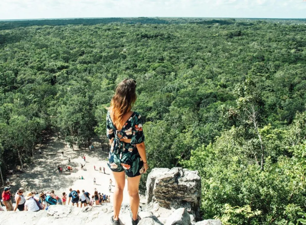 Woman standing at the top of the main pyramid at Coba.