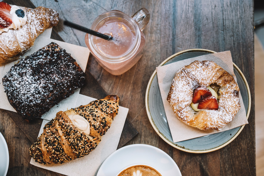 An assortment of pastries and a jar of fresh juice