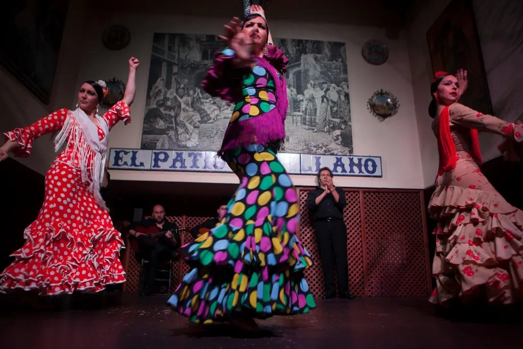 Three women dancing flamenco on stage 