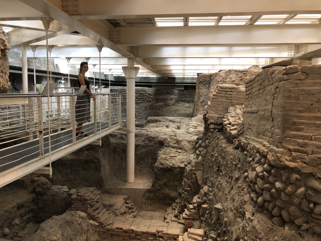 A woman admiring the Roman ruins of Sala Borsa in Bologna