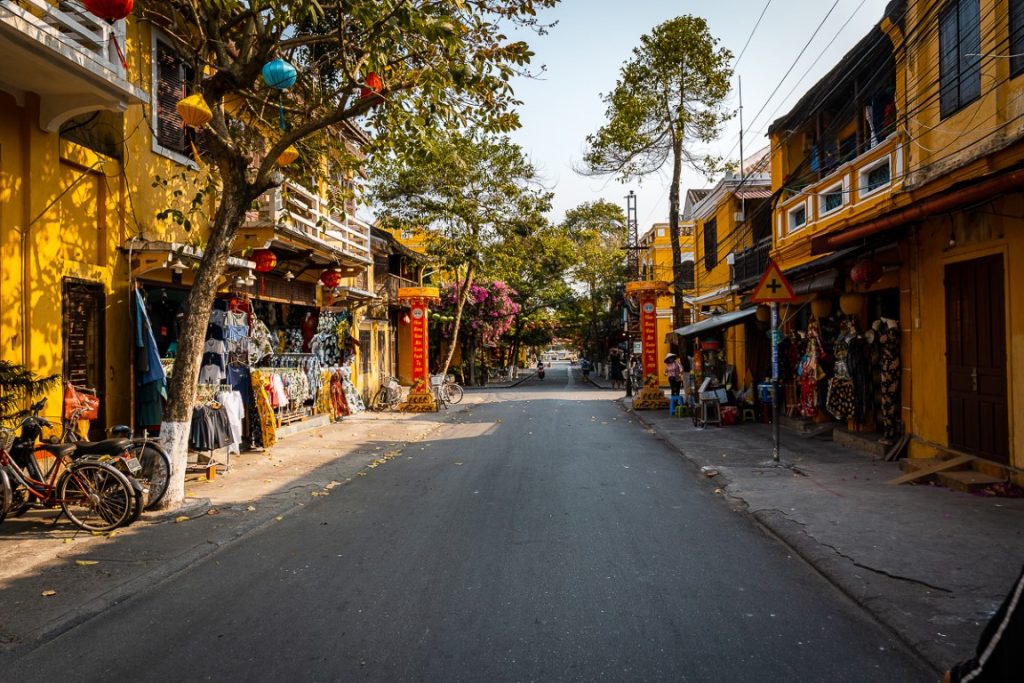 A street lined by yellow building in Hoi An