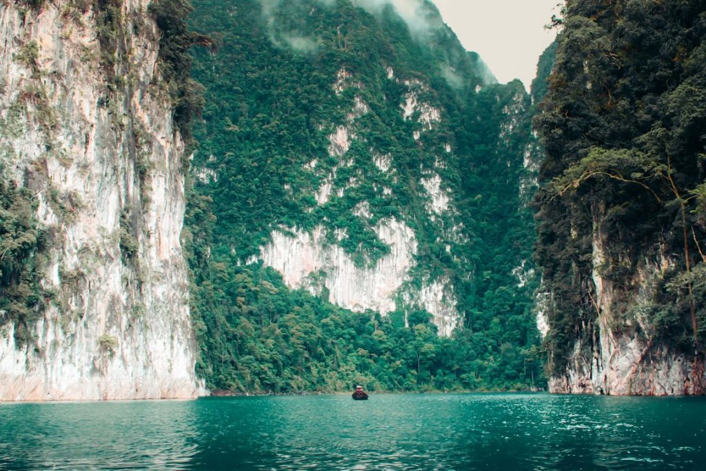 Massive karsts covered in vegetation, and a lake in the center