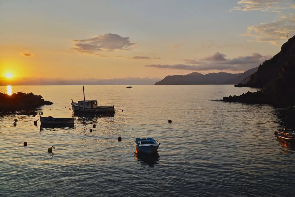 Three boats on the sea during sunset