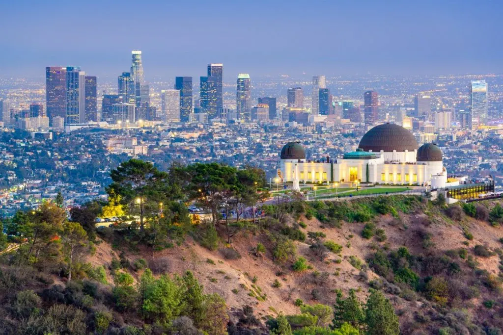 The city of Los Angeles lit up at dusk, and the Griffith Observatory in the forefront