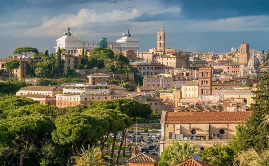 One of the best views in Rome, featuring pastel orange houses and the monument Altare della Patria in the distance