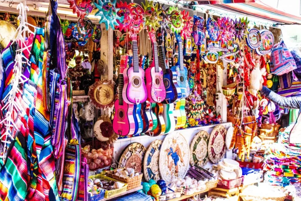 colorful Mexican ornaments, guitars, and decor at a street market