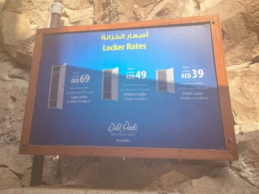 A sign with locker rates information at WIld Wadi Waterpark