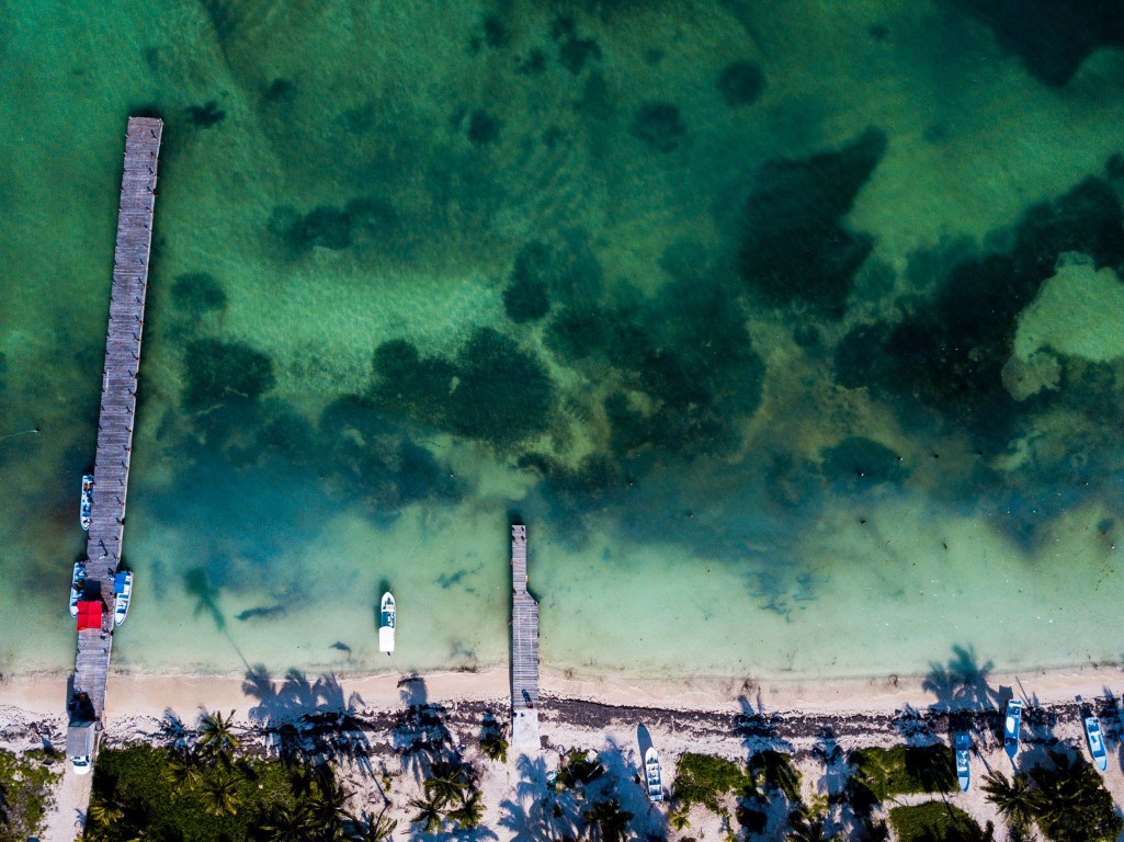Drone picture of the water, beach and pier in Punta Allen in Sian Ka'an.