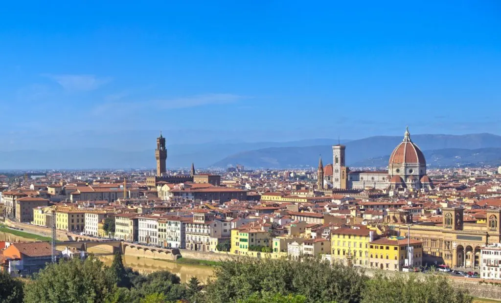 Santa Maria del Fiore Cathedral and the  Tower of Arnolfo standing out in a sea of terracotta rooftops, seen from across the river