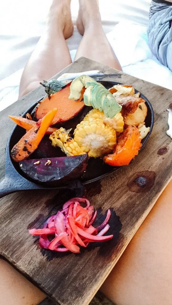 A plate of roasted vegetables on a wooden board