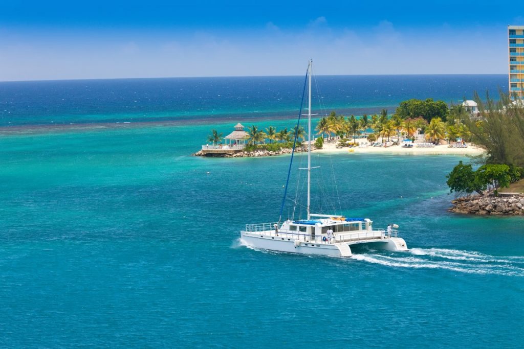 A yacht sailing in blue waters, one of the best day trips from Playa del Carmen