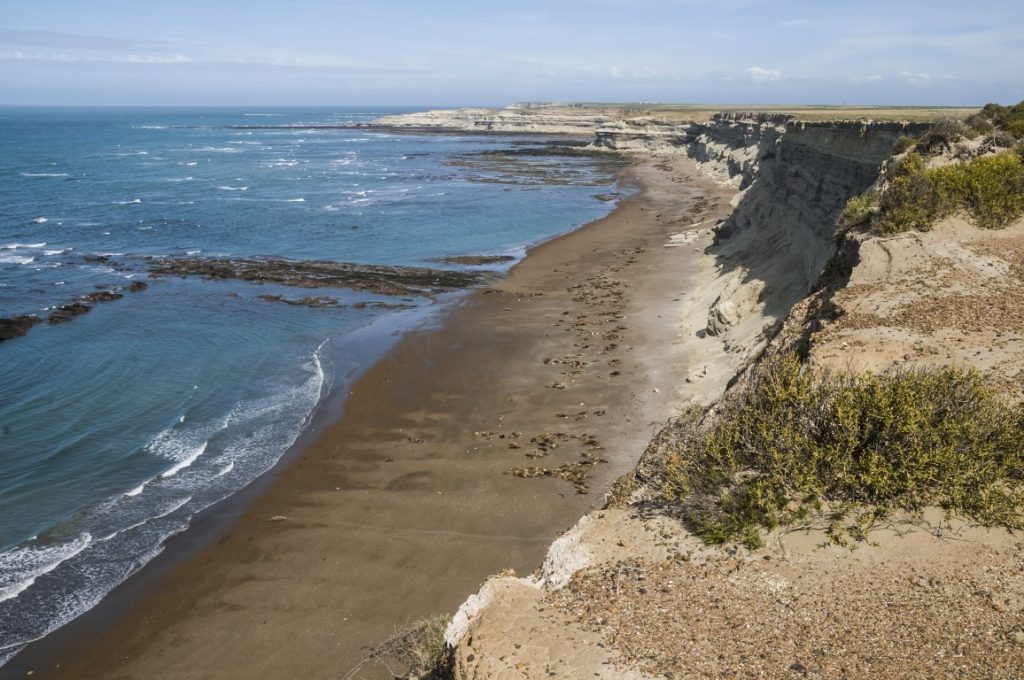 A beach lined by sandy cliffs