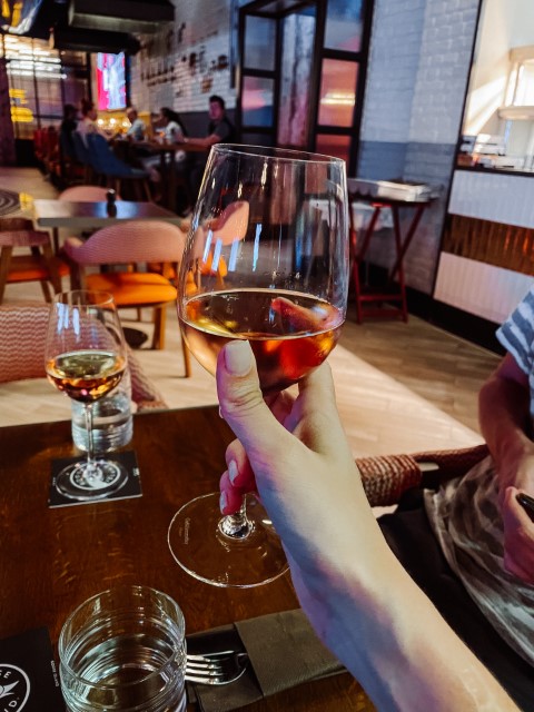 A woman's hand holding a glass of wine