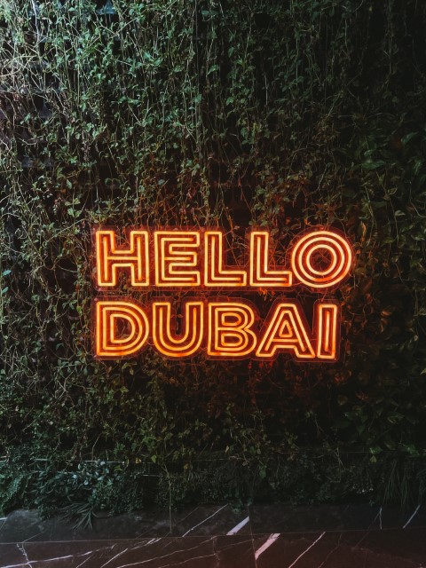 A neon sign that reads Hello Dubai