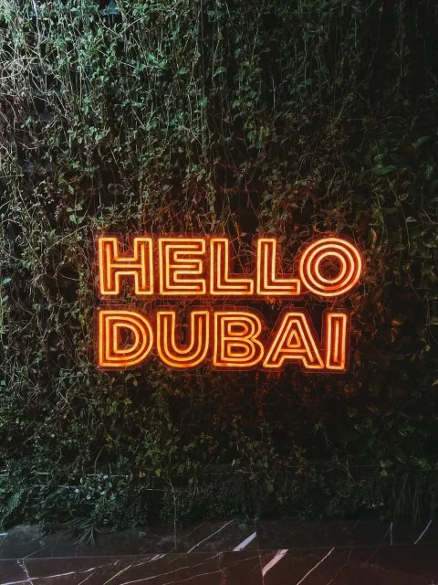 A neon sign that reads Hello Dubai