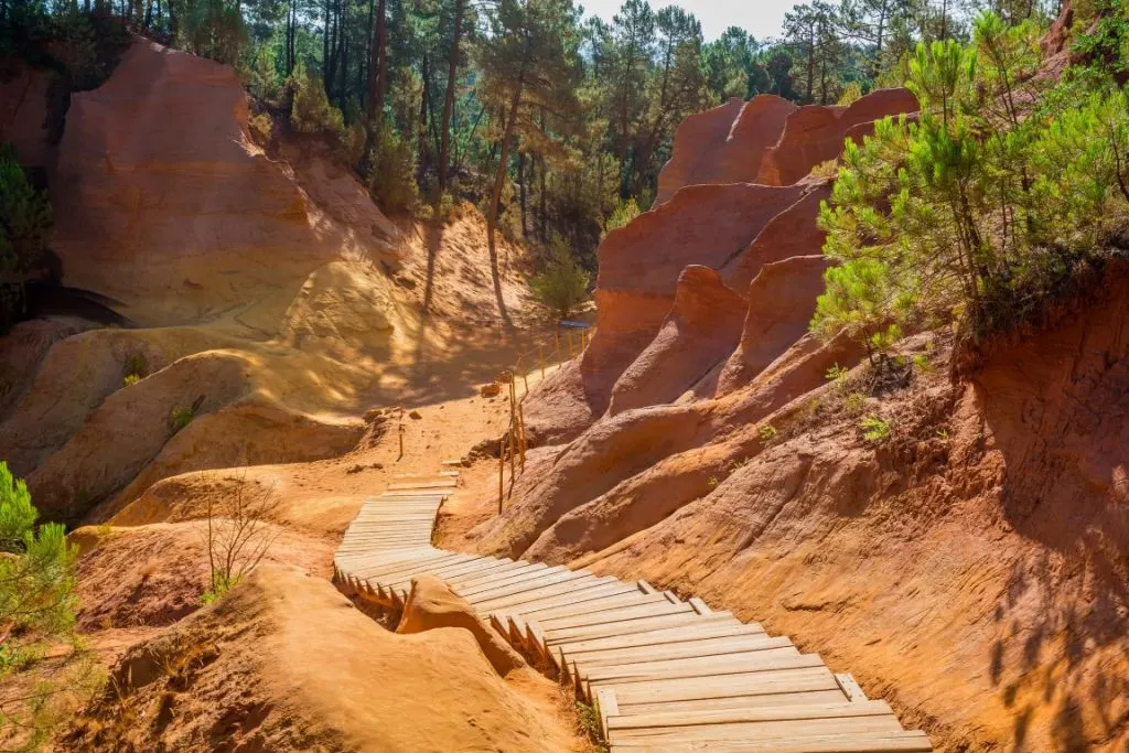 the Ochre Trail in Roussillon lined by ochre-colored cliffs