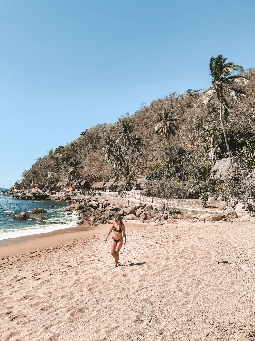 A woman walking on the beach in Puerto Vallarta