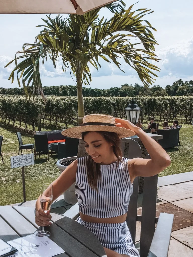 Photo of a woman with a glass of wine at Sparkling Pointe winery