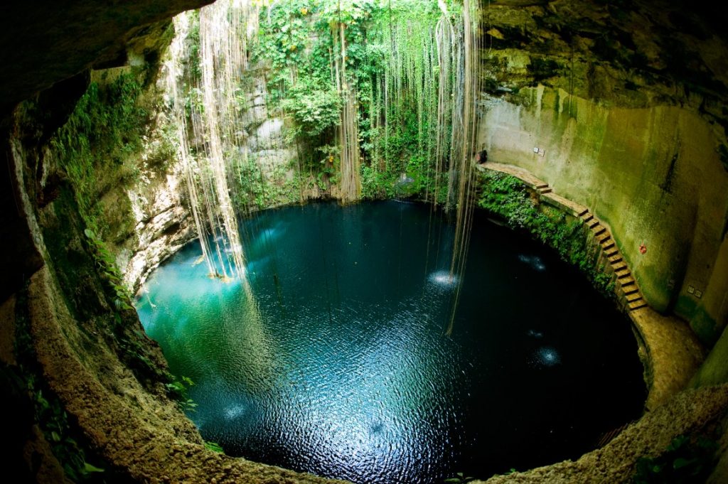 Image of a natural sinkhole seen from above, inserted in a post about the best Merida Cenote Tours