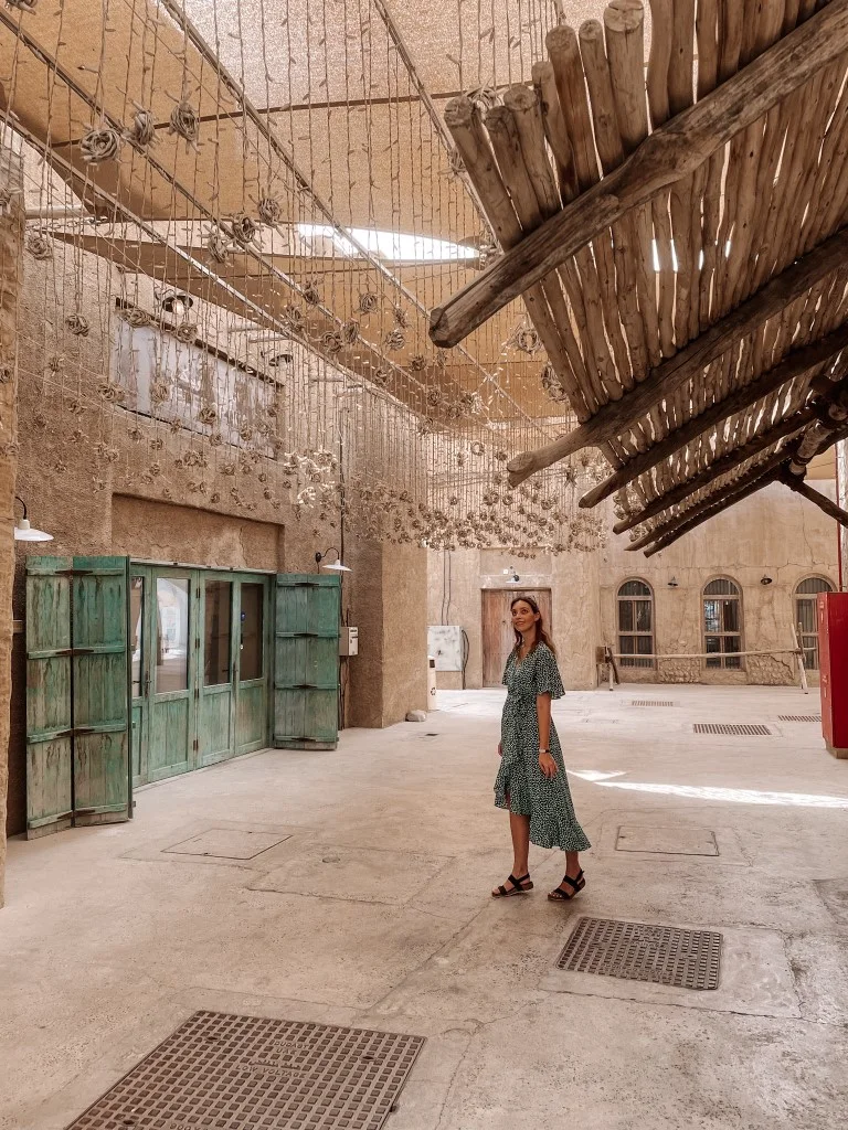 A woman strolling around the Al Seef neighborhood