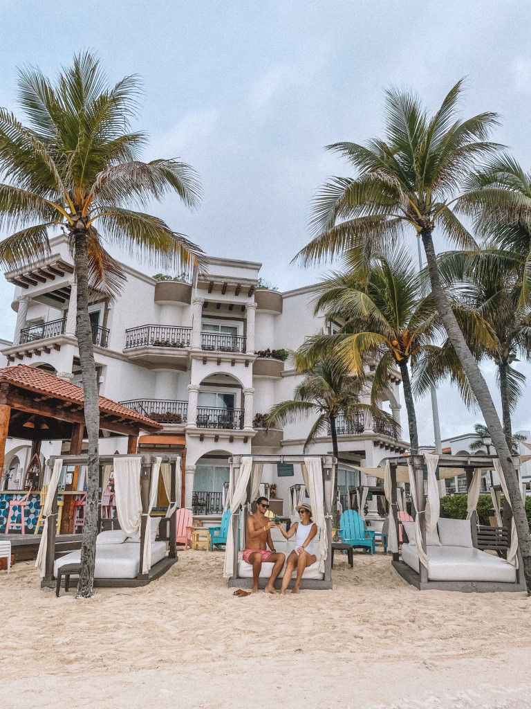 A couple relaxing in a beach cabana 