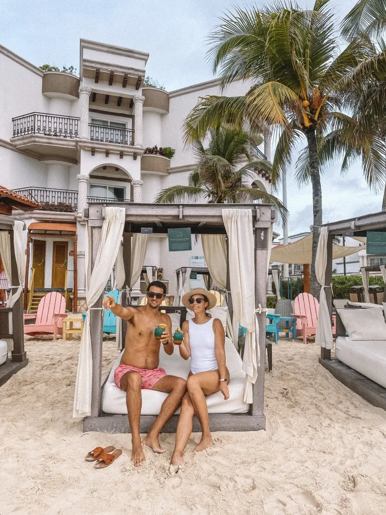 A couple sitting in a beach Cabana in Playa del Carmen, one of the best cities in Mexico