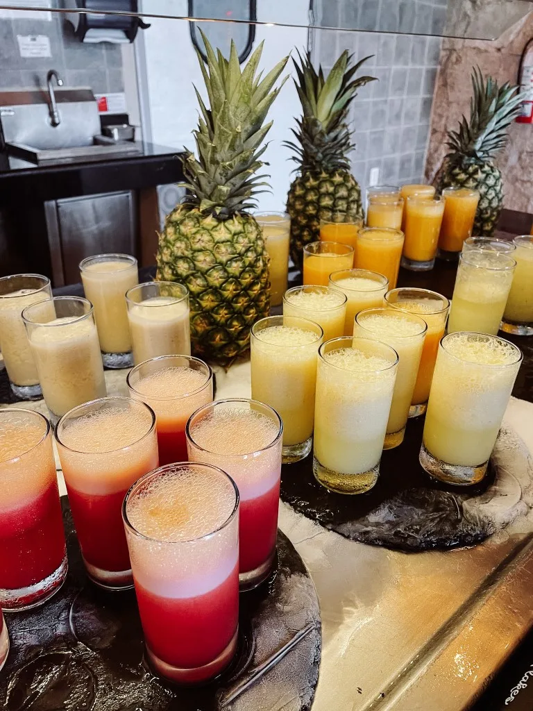 Various glasses of juice set at a breakfast bar