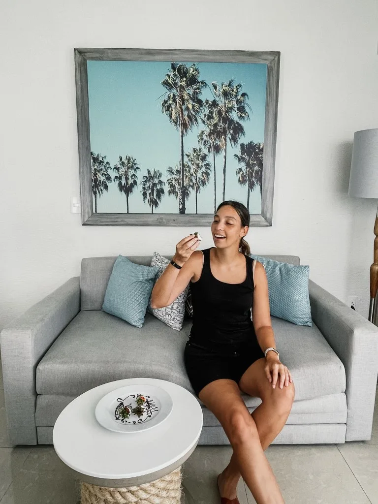 A woman eating the complimentary biscuits left at the room in Wyndham Alltra Cancun