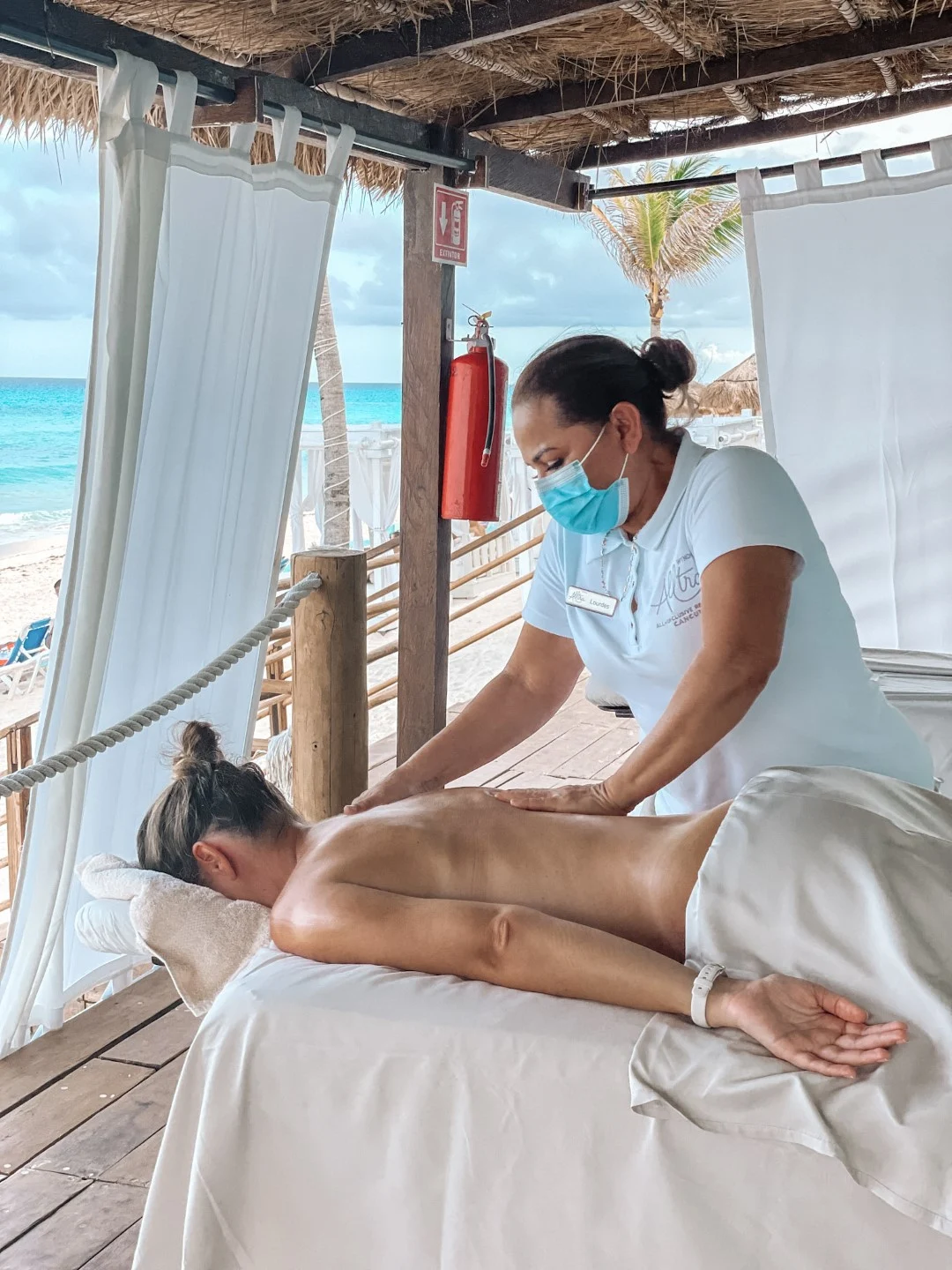 A woman receiving a massage by the beach